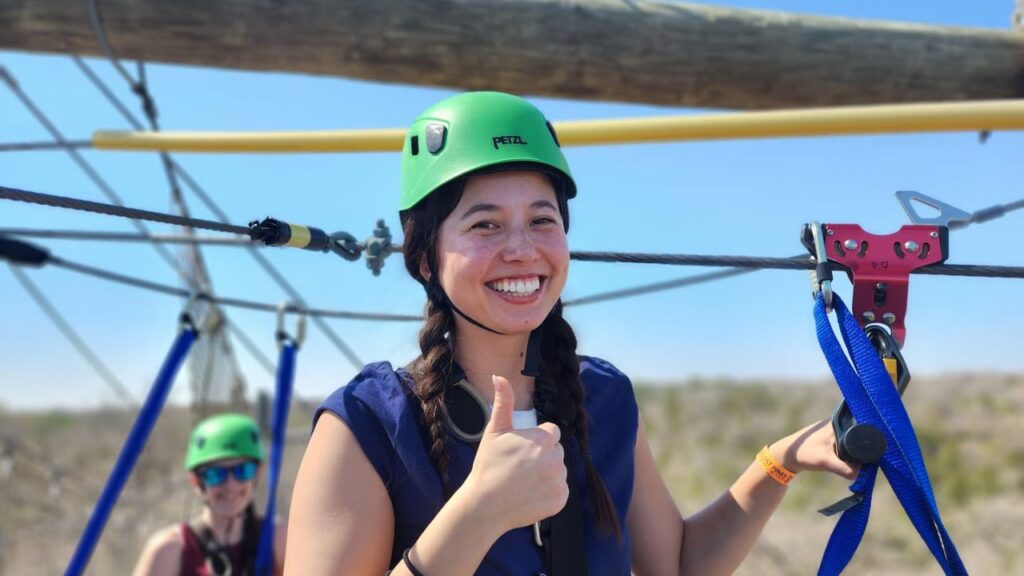 Woman posing with scenic views at the Zip Lost Pines adventure park.