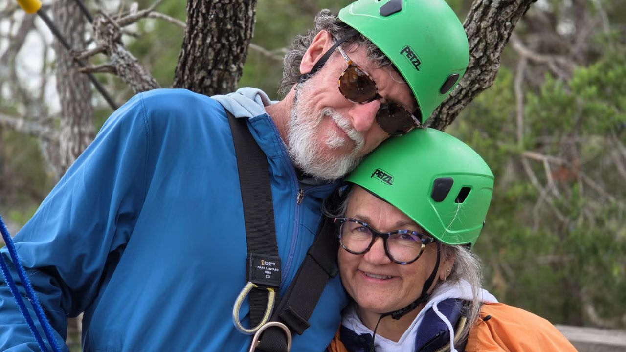 Couple posing with scenic pine forest views at Zip Lost Pines.