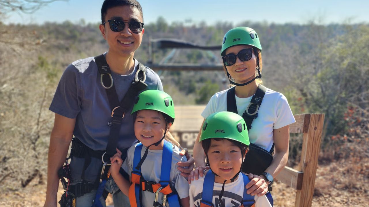 Family posing together before their zipline adventure at Zip Lost Pines.