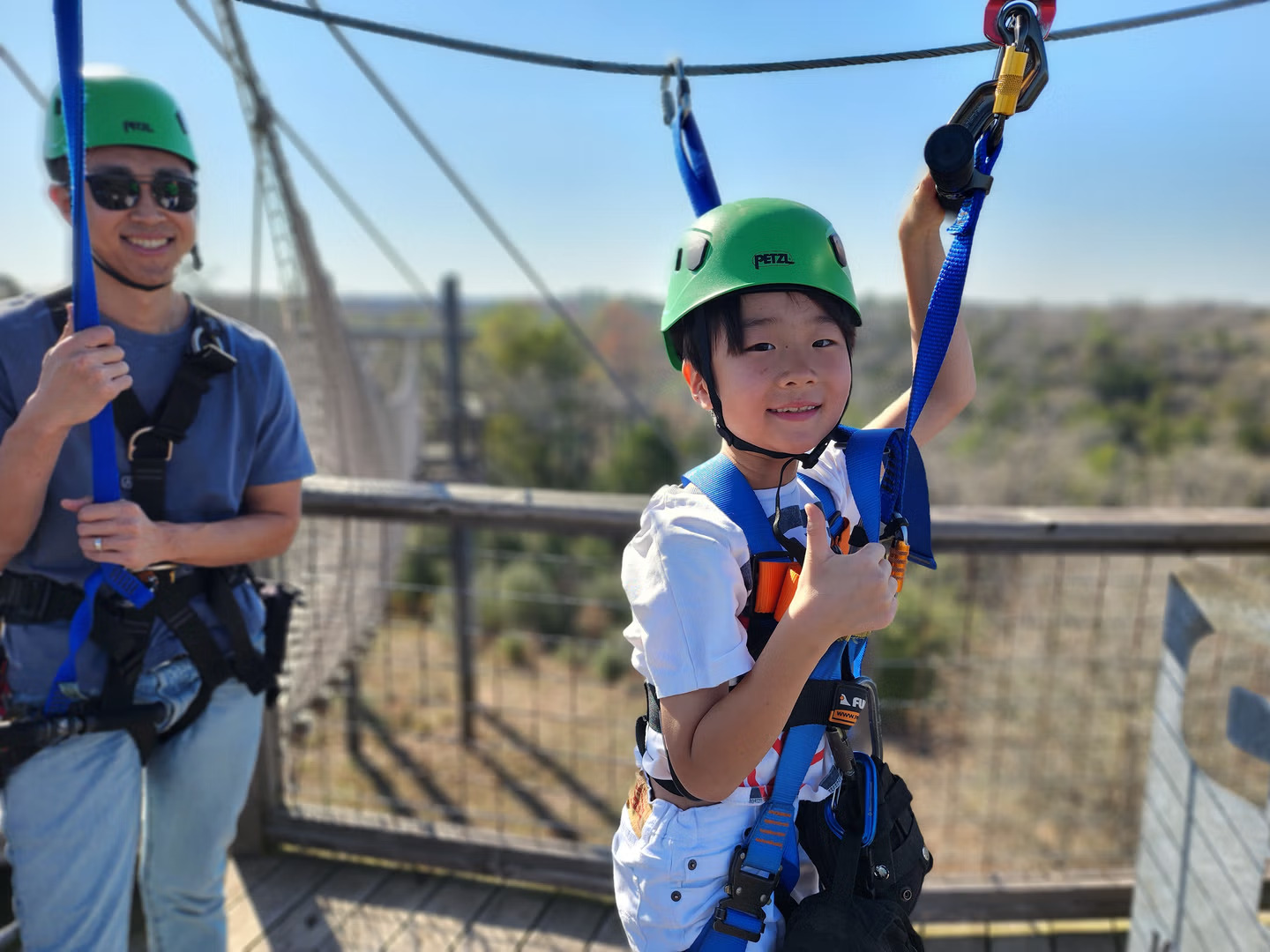 Child having fun during a zipline adventure at Zip Lost Pines