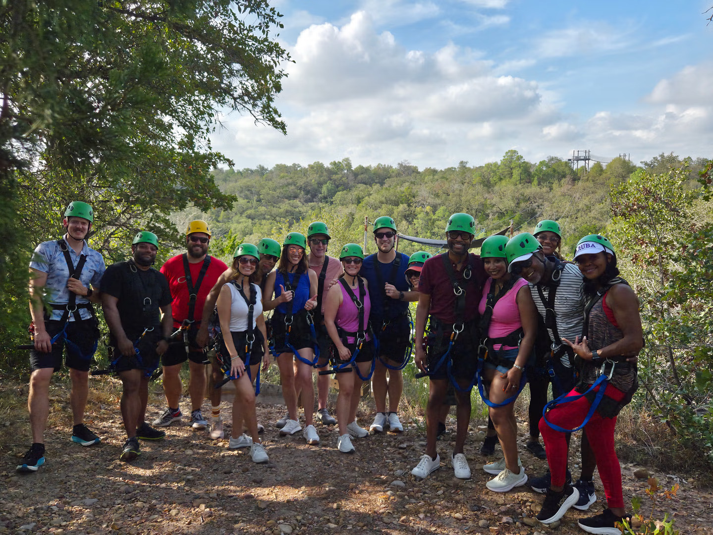 Group of people having fun during a zipline adventure at Zip Lost Pines