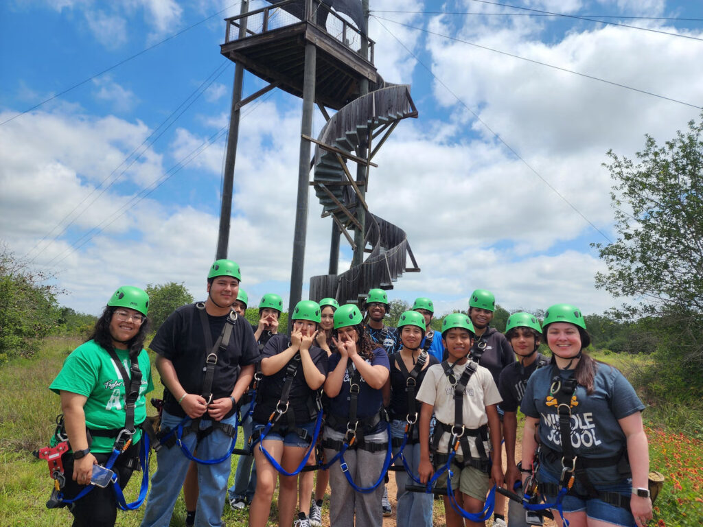 Group of people posing before their zipline adventure