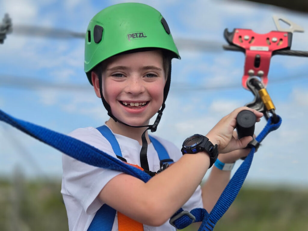 Kid enjoying an outdoor zipline adventure together at Zip Lost Pines