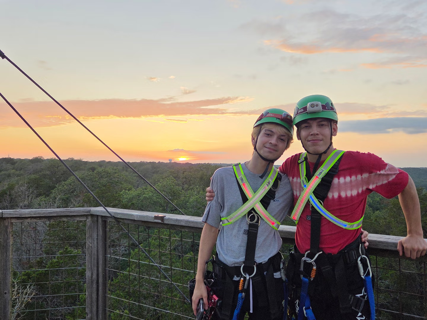 People posing together at Zip Lost Pines as evening approaches