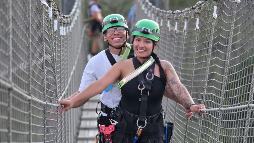 People posing after enjoying a zipline adventure