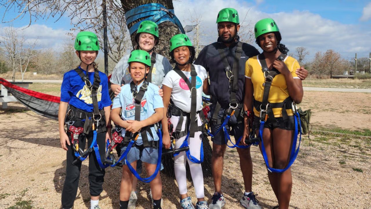 Family posing together before their zipline adventure.