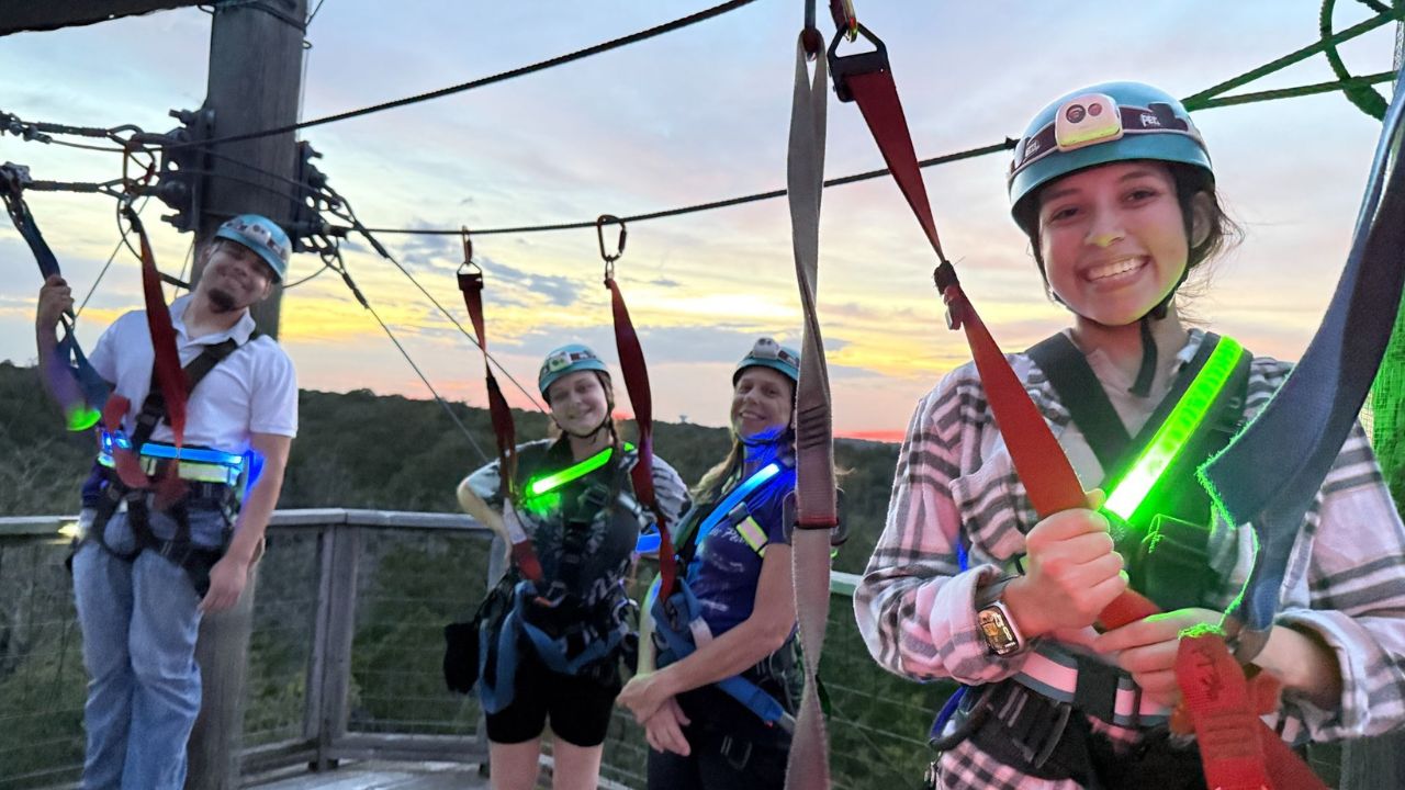 People enjoying an evening zipline adventure