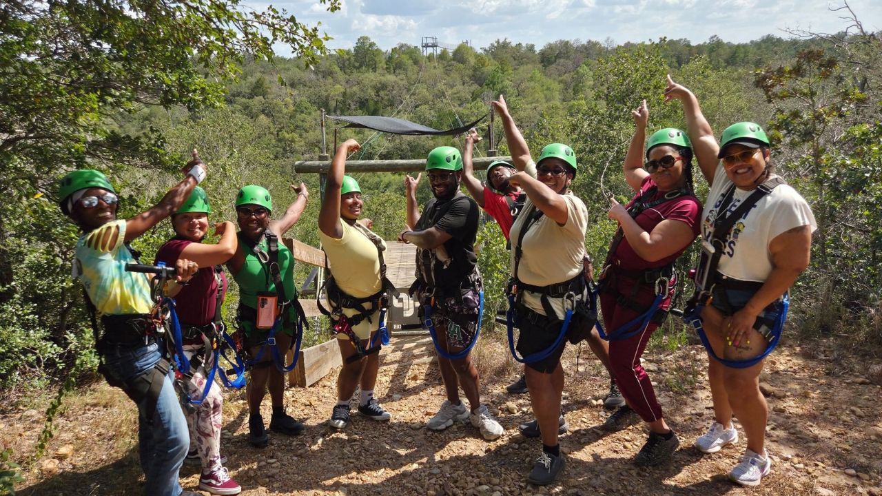 People enjoying and posing during a Lost Pines zipline experience