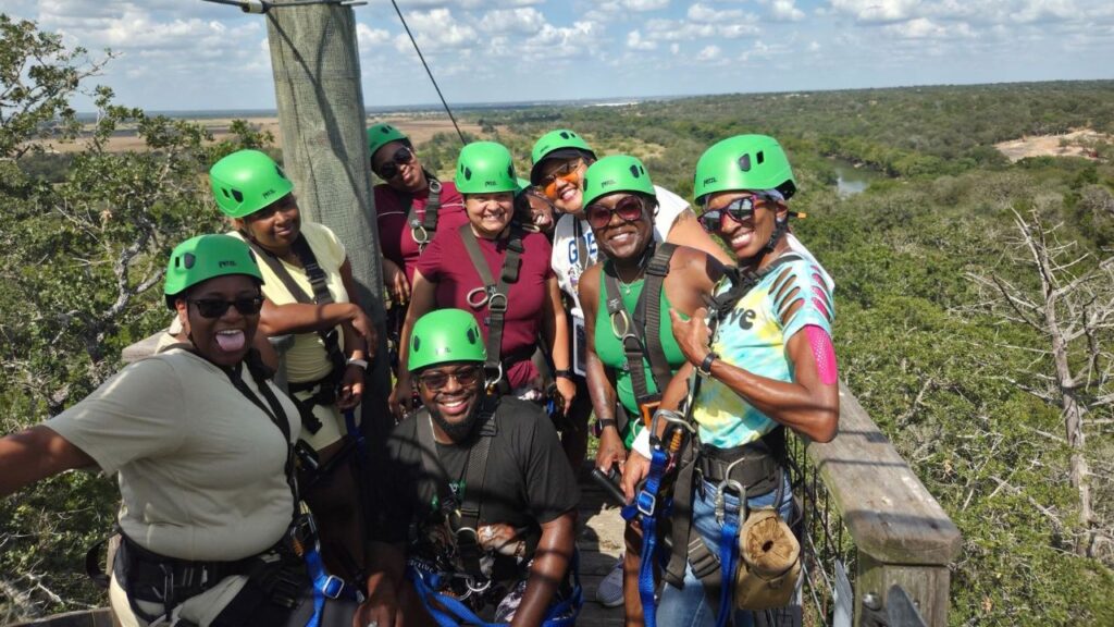 Parents taking part in a Lost Pines zipline adventure