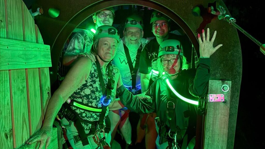 Visitors enjoying a nighttime zipline adventure at Zip Lost Pines