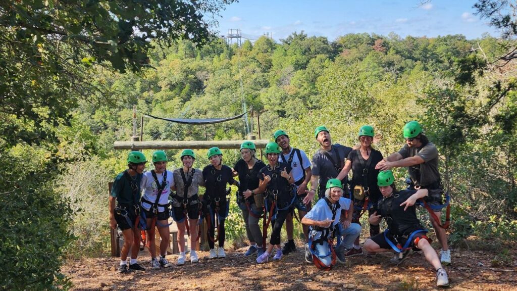 Group of people enjoying a ziplining adventure at Zip Lost Pines